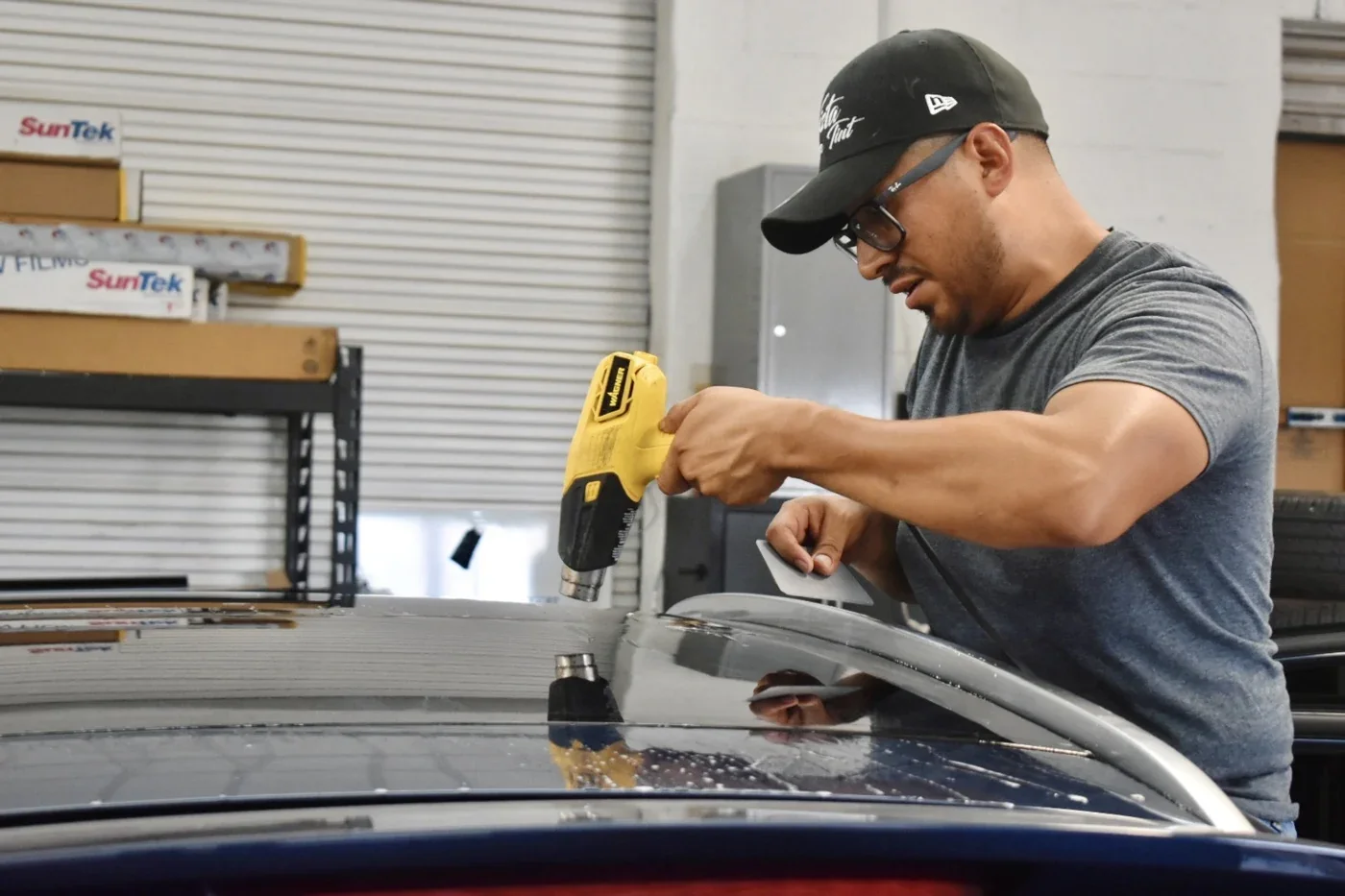 Vista installer shaping window film with a heat gun
